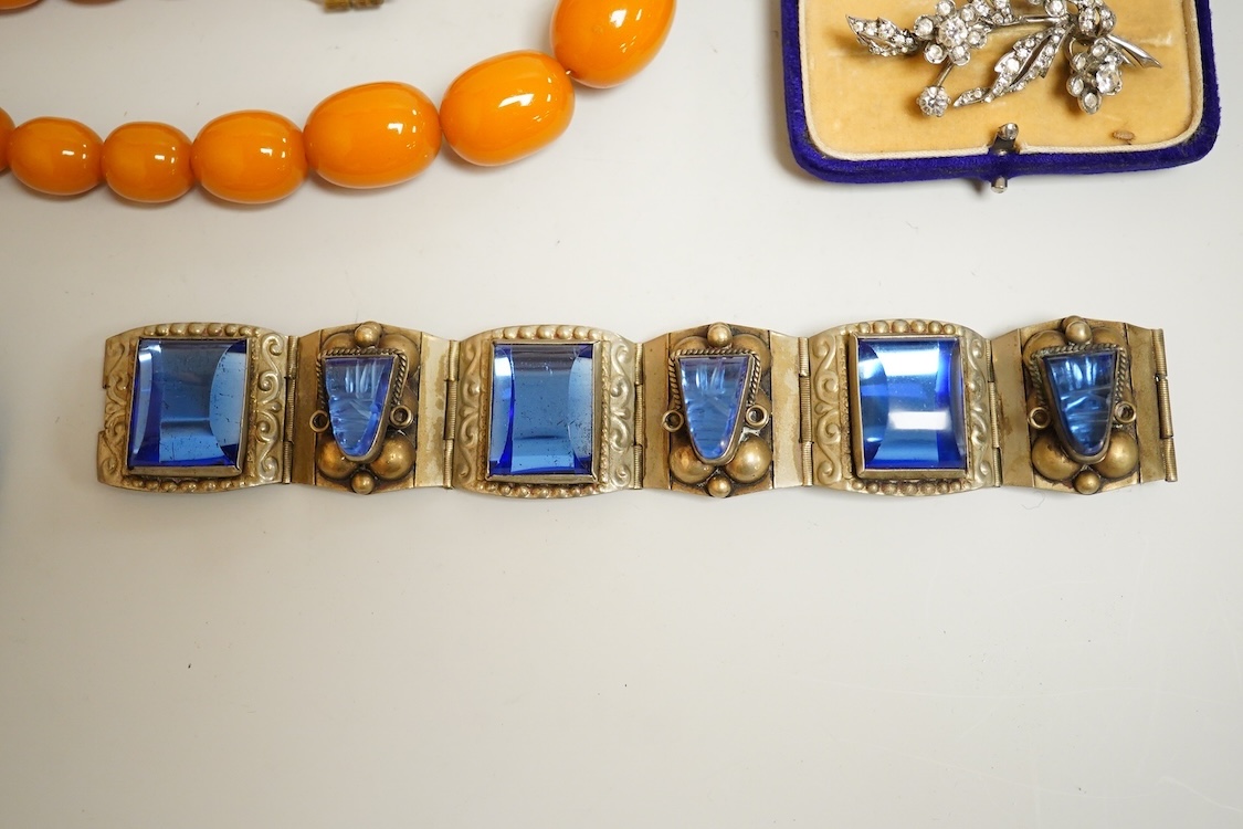 A group of antique and later jewellery inc. cased paste set spray brooch, a Mexican paste set brooch, a paste set shoe buckle and a pressed amber necklace.